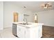Modern kitchen island with stainless steel appliances and white cabinets, offering a sleek and functional workspace at 1947 Vienna Ave, Deltona, FL 32725