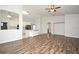 Bright open-concept living space with wood floors and modern ceiling fan at 1947 Vienna Ave, Deltona, FL 32725