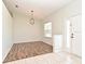 Bright living room features wood-look flooring, neutral walls, new light fixture and ample natural light at 1947 Vienna Ave, Deltona, FL 32725