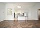 Open living space featuring wood flooring and seamless flow to the kitchen at 1947 Vienna Ave, Deltona, FL 32725
