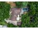 An aerial view of the house showing its roof and landscaping including the pool and driveway at 2009 Woody Dr, Windermere, FL 34786