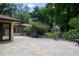 Spacious backyard with manicured landscaping, a wrought iron fence, and a large birdcage at 2009 Woody Dr, Windermere, FL 34786