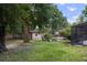 Spacious backyard with mature trees, a screened-in pool, and a lush green lawn at 2009 Woody Dr, Windermere, FL 34786