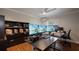 Office with hardwood floors, a ceiling fan, and large desk and shelving units at 2009 Woody Dr, Windermere, FL 34786