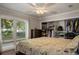 Bedroom features ample closet space, hardwood floors and multiple large windows at 2009 Woody Dr, Windermere, FL 34786