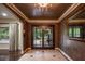 Elegant foyer with decorative tile flooring, stylish chandelier, and double doors at 2009 Woody Dr, Windermere, FL 34786