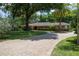 Beautiful brick home with well-manicured lawn and elegant circular driveway entrance at 2009 Woody Dr, Windermere, FL 34786