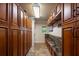 Hallway features wood cabinets with granite counters and travertine flooring at 2009 Woody Dr, Windermere, FL 34786