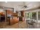 Traditional kitchen with wood cabinets, center island, stainless hood and view of an outdoor patio with table set at 2009 Woody Dr, Windermere, FL 34786