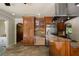 Bright kitchen features wood cabinets, stone counters, stainless appliances, and travertine flooring at 2009 Woody Dr, Windermere, FL 34786