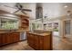 Beautiful kitchen with a center island cooktop, wood cabinets, and access to the outdoor area at 2009 Woody Dr, Windermere, FL 34786