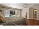 Bright main bedroom boasts hardwood floors and views of the outdoor pool area at 2009 Woody Dr, Windermere, FL 34786