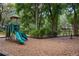 Community playground with play structure, benches, spring rider and mulch ground covering at 2009 Woody Dr, Windermere, FL 34786