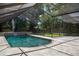 Relaxing screened-in pool with waterfalls and lush greenery providing shade at 2009 Woody Dr, Windermere, FL 34786