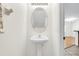 Bathroom with pedestal sink, decorative mirror, and tiled floor at 221 Sterling Springs Ln, Altamonte Springs, FL 32714
