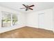 Bright bedroom with hardwood floors, closet, and natural light from the window at 221 Sterling Springs Ln, Altamonte Springs, FL 32714