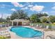 Community pool area features lounge chairs and a cabana with a bright blue sky at 221 Sterling Springs Ln, Altamonte Springs, FL 32714