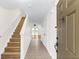Inviting entryway featuring neutral-toned walls, tile floors, and wood stairs leading to the upper level at 221 Sterling Springs Ln, Altamonte Springs, FL 32714