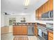 Well-equipped kitchen with stainless steel appliances, and a view of the bright living room and dining area at 221 Sterling Springs Ln, Altamonte Springs, FL 32714