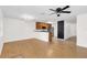 Open layout seamlessly connecting kitchen and living space with hardwood floors, fan, and neutral-toned walls at 221 Sterling Springs Ln, Altamonte Springs, FL 32714