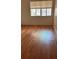 The bedroom has laminate wood flooring and a window that lets in natural light at 2235 Silver Pines Pl # 401, Orlando, FL 32808