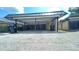 Carport area of a residential property, featuring parking and adjacent residential building exteriors at 2235 Silver Pines Pl # 401, Orlando, FL 32808