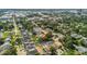An aerial shot reveals a neighborhood with tree-lined streets near commercial areas and a bustling cityscape at 232 E Grant St, Orlando, FL 32806