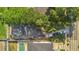 Aerial view of property showing driveway, cars, lush landscaping, pool, and proximity to street at 232 E Grant St, Orlando, FL 32806