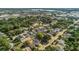 This aerial view highlights the tree-filled neighborhood featuring a combination of houses and local businesses at 232 E Grant St, Orlando, FL 32806