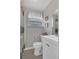 Bright bathroom featuring black and white floors, and shower with window at 232 E Grant St, Orlando, FL 32806