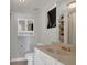 Clean bathroom with granite countertop, mirrored cabinet, and shower/tub combo at 232 E Grant St, Orlando, FL 32806