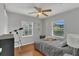 Bright bedroom with ceiling fan, two windows, and comfortable furniture at 232 E Grant St, Orlando, FL 32806