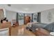 Cozy bedroom featuring hardwood floors, two windows with curtains, and comfortable furniture at 232 E Grant St, Orlando, FL 32806