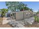 Exterior view of home with shed and large concrete parking area at 232 E Grant St, Orlando, FL 32806