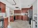 Spacious kitchen featuring dark wood cabinets, tile floors, and modern appliances at 232 E Grant St, Orlando, FL 32806