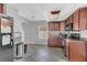 Well-lit kitchen featuring tiled flooring, updated appliances, and ample counter space at 232 E Grant St, Orlando, FL 32806