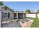Covered patio that leads to a backyard with white privacy fence at 232 E Grant St, Orlando, FL 32806