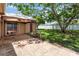 View of the backyard featuring a covered patio, grassy area, and mature shade trees at 2407 Accord Ter, Kissimmee, FL 34758
