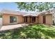 View of the backyard featuring a covered patio, grass, landscaping, and access to the house at 2407 Accord Ter, Kissimmee, FL 34758
