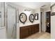 Bathroom featuring double sinks, tiled floors, a walk-in shower, and storage at 2407 Accord Ter, Kissimmee, FL 34758