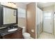 Neutral bathroom with a dark sink, mirror, and shower at 2407 Accord Ter, Kissimmee, FL 34758