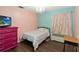 Bright bedroom with pink and blue walls, a chandelier, and hardwood floors at 2407 Accord Ter, Kissimmee, FL 34758