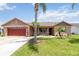 Charming single-story home features a well-manicured lawn and mature landscaping at 2407 Accord Ter, Kissimmee, FL 34758