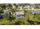 Find yourself near a pond as seen in this aerial view of the area and home with a pool at 2562 Sheffield Dr, Deltona, FL 32738