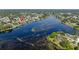 This is an aerial view of the neighborhood near the water and many green trees at 2562 Sheffield Dr, Deltona, FL 32738