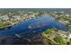 This is an aerial view of the neighborhood near the water and many green trees at 2562 Sheffield Dr, Deltona, FL 32738