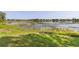Scenic backyard featuring a tranquil lake view, with lush greenery and natural shoreline at 2562 Sheffield Dr, Deltona, FL 32738