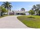 Well-maintained single-story home with a circular driveway and lush green lawn at 2562 Sheffield Dr, Deltona, FL 32738