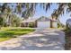 Two-car garage door and brick accents contribute to the home's curb appeal at 2562 Sheffield Dr, Deltona, FL 32738