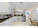 Bright white kitchen with stainless steel appliances and a view towards the lanai at 2562 Sheffield Dr, Deltona, FL 32738